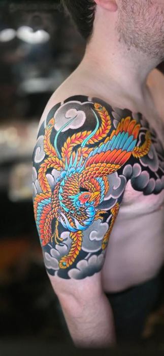 Japanese dragon across the shoulder in orange and blue
